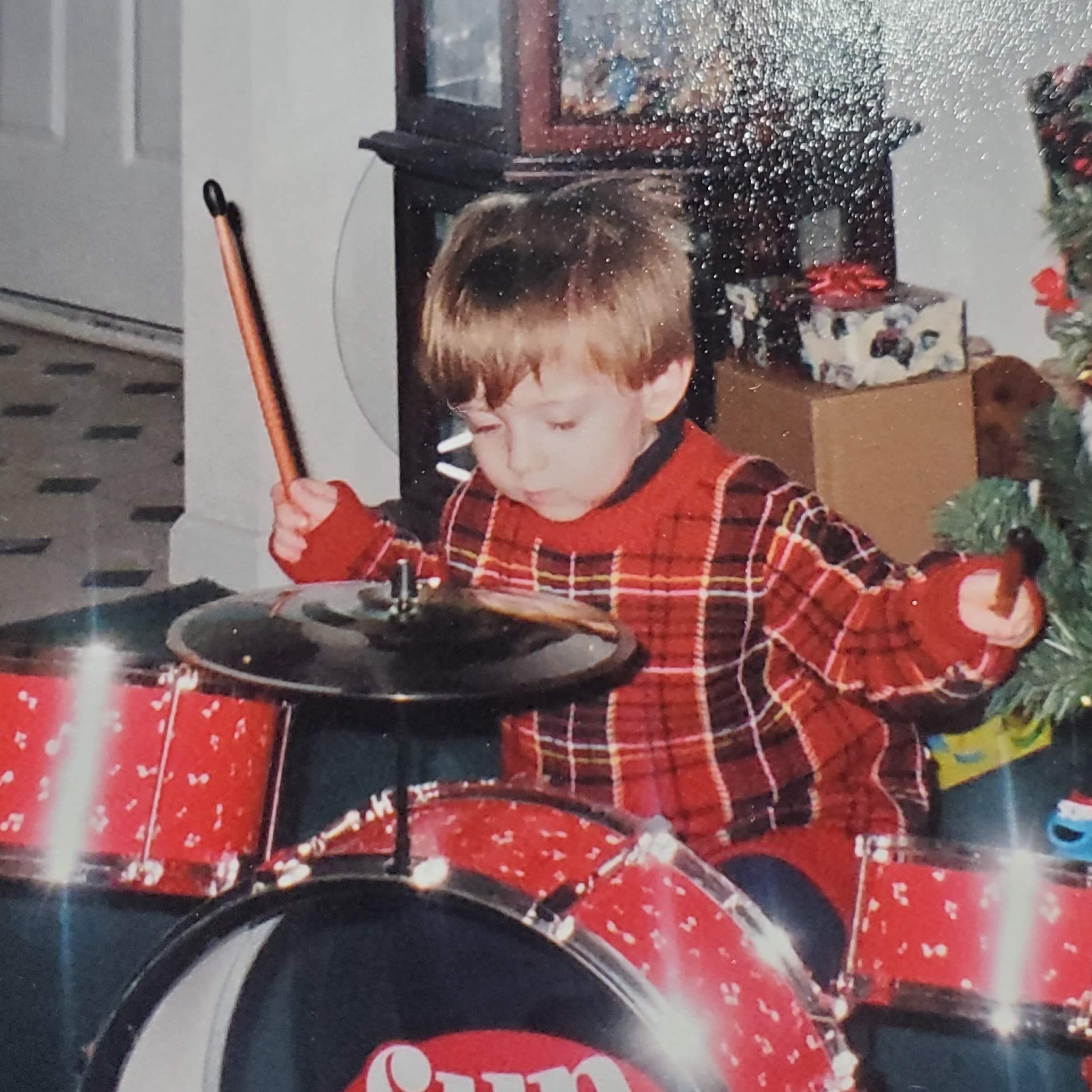 Four-year-old (ish) Kyle at a drumset he got for Christmas